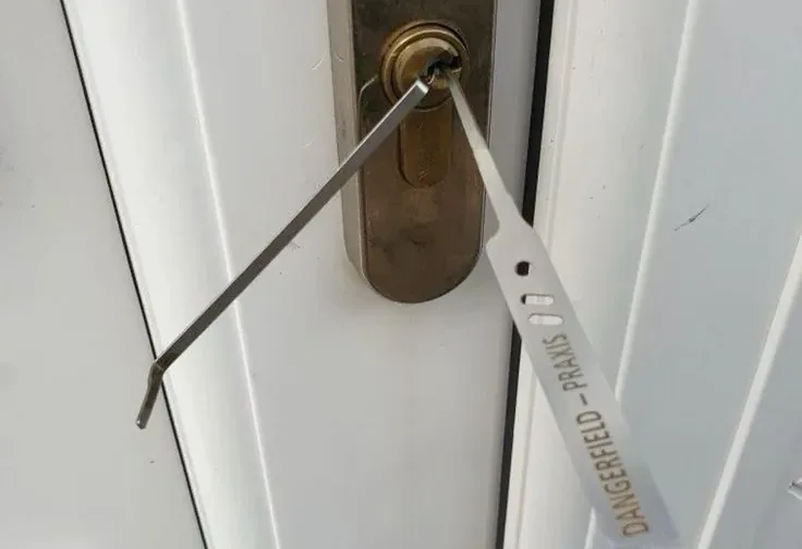 A key being used at a residential door lock.