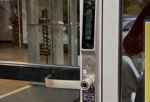 Keypad smart lock installed on a commercial storefront door.