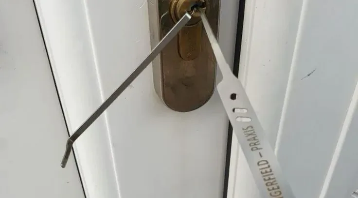 A key being used at a residential door lock.