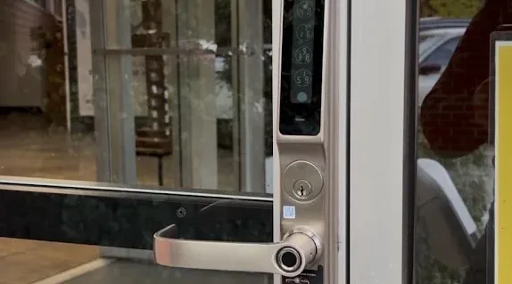 Keypad smart lock installed on a commercial storefront door.