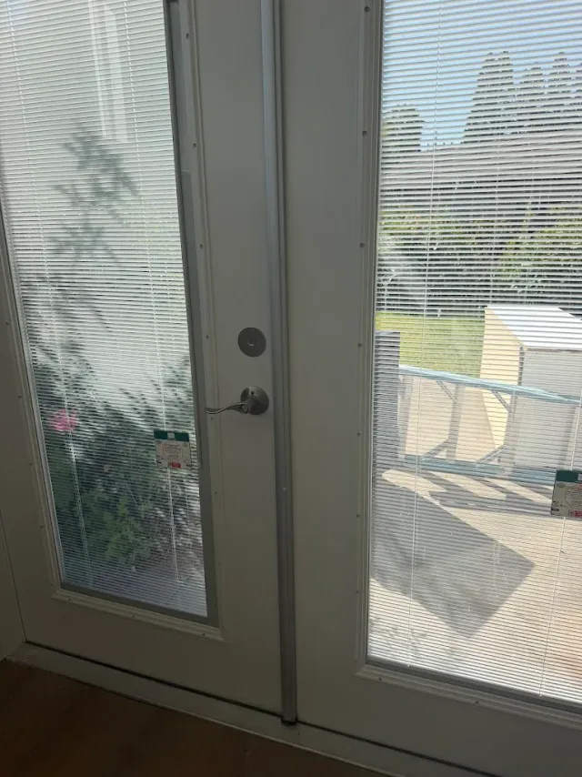 Glass-panel side door and frame at a commercial property.