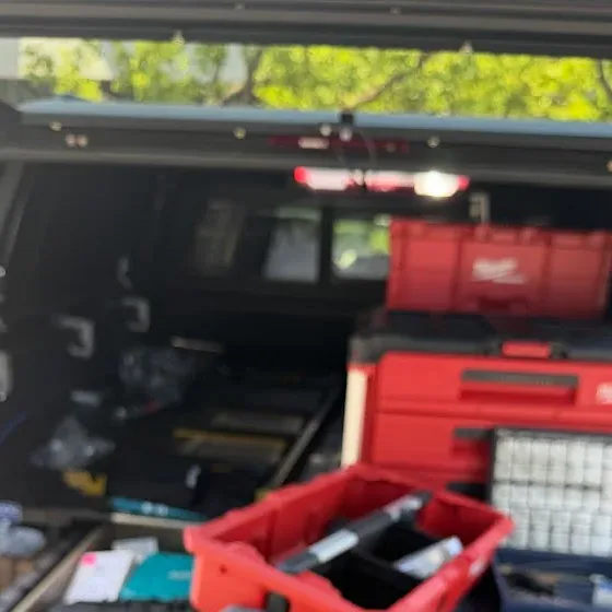 Locksmith tool cases and key-cutting equipment in a service vehicle